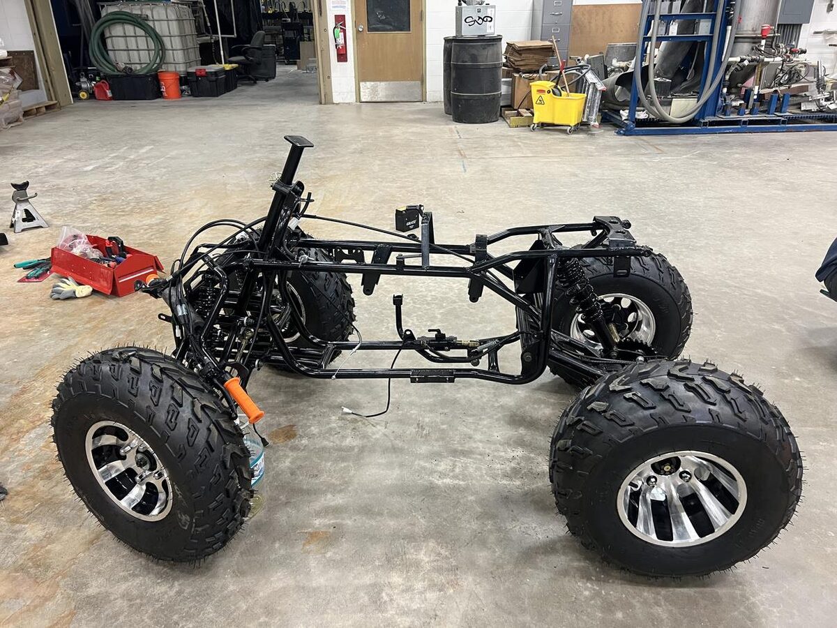 Bare ATV chassis frame with wheels mounted
